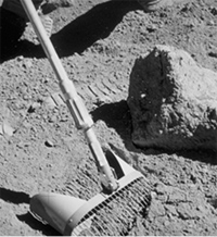 Astronaut collecting soil sample