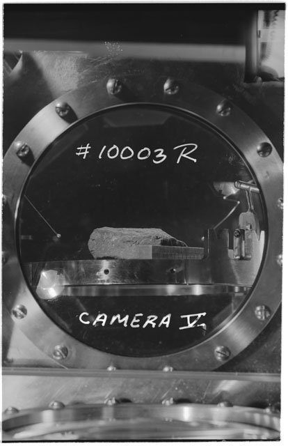 Black and white photograph of Apollo 11 Sample(s) 10003; Processing photograph displaying sample in vaccum vault with camera V.