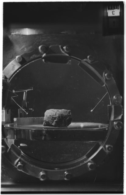 Black and white photograph of Apollo 11 Sample(s) 10003; Processing photograph displaying sample in vaccum vault with camera III.