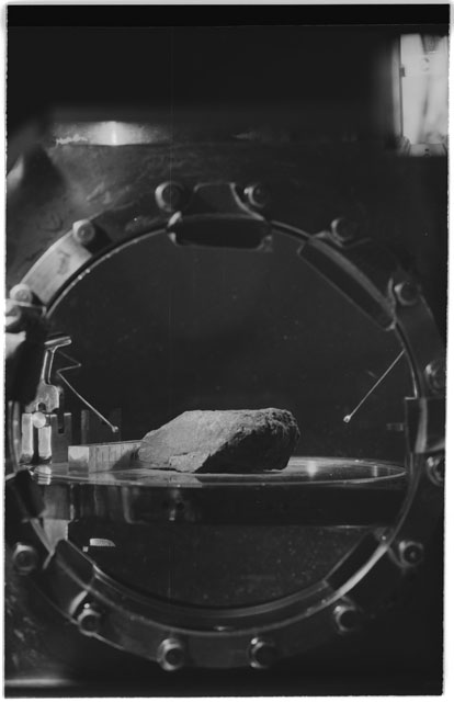 Black and white photograph of Apollo 11 Sample(s) 10003; Processing photograph displaying sample in vaccum vault with camera III.