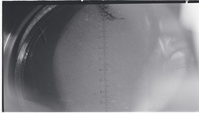 Black and white photograph of Apollo 11 Sample(s) 10010; Processing photograph displaying sieving core tube material.
