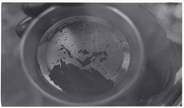 Black and white photograph of Apollo 11 Sample(s) 10010; Processing photograph displaying sieving core tube material.