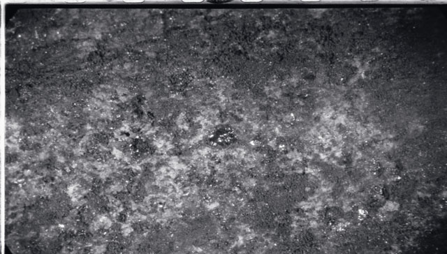 Black and white photograph of Apollo 11 Sample(s) 10003; Processing photograph displaying close up view of a fines with glass.