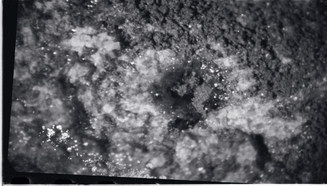 Black and white photograph of Apollo 11 Sample(s) 10003; Processing photograph displaying close up view of a Glass VUG.