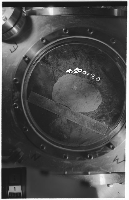 Black and white photograph of apollo 11 Sample(s) 10019,0; Processing photograph displaying sample in vacuum vault at R1P.