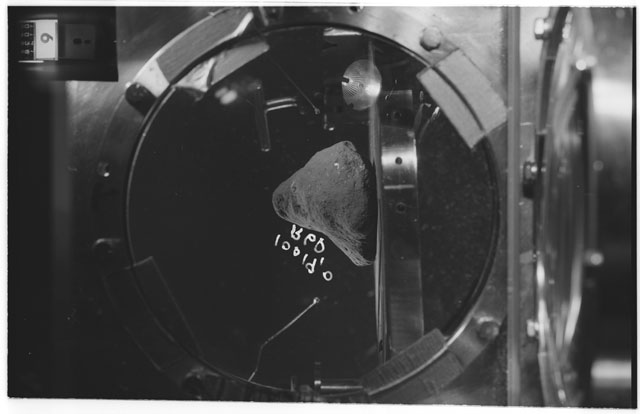 Black and white photograph of apollo 11 Sample(s) 10019,0; Processing photograph displaying sample in vacuum vault at R6P.