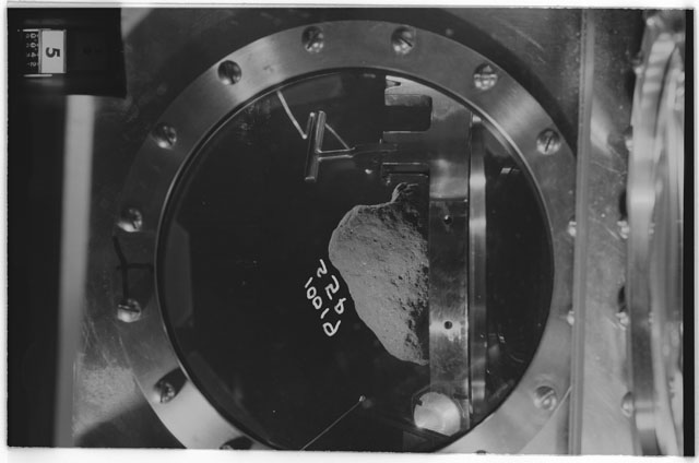 Black and white photograph of apollo 11 Sample(s) 10019; Processing photograph displaying sample in vacuum vault at S5P.
