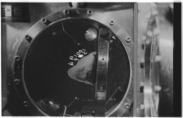 Black and white photograph of apollo 11 Sample(s) 10019; Processing photograph displaying sample in vacuum vault at S4P.