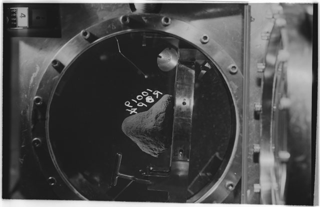 Black and white photograph of apollo 11 Sample(s) 10019; Processing photograph displaying sample in vacuum vault at R4P.