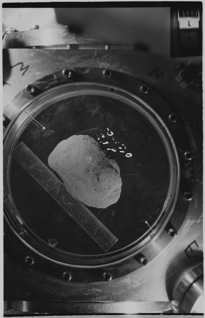 Black and white photograph of apollo 11 Sample(s) 10019; Processing photograph displaying sample in vacuum vault at R1P.