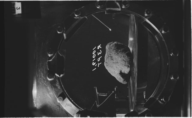 Black and white photograph of apollo 11 Sample(s) 10019,1; Processing photograph displaying sample in vacuum vault at R3PT.