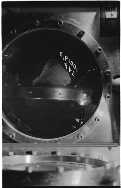 Black and white photograph of apollo 11 Sample(s) 10019,0; Processing photograph displaying sample in vacuum vault at S4P.