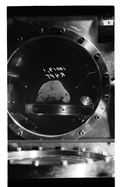 Black and white photograph of apollo 11 Sample(s) 10019,1; Processing photograph displaying sample in vacuum vault at R4PT.