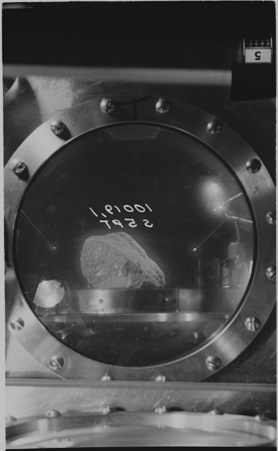 Black and white photograph of apollo 11 Sample(s) 10019,1; Processing photograph displaying sample in vacuum vault at S5PT.