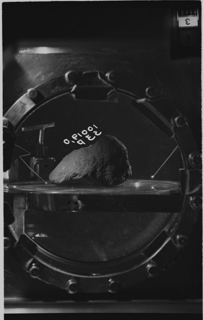 Black and white photograph of apollo 11 Sample(s) 10019,0; Processing photograph displaying sample in vacuum vault at S3P.