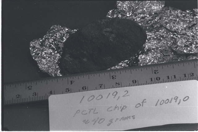 Black and white photograph of Apollo 11 Sample(s) 10019,2; Processing photograph displaying a 40 gram chip of PCTL.