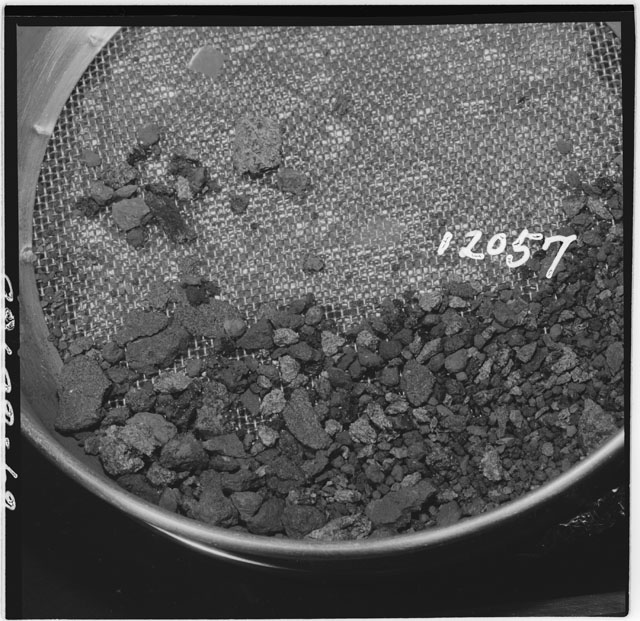 Black and white photograph of Apollo 12 Sample(S) 12057; Processing photograph displaying an sieving of rake samples.
