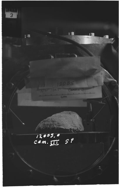 Black and white photograph of Apollo 12 Sample(S) 12005,0; Processing photograph displaying the sample using Camera III.