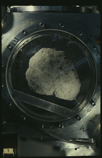 Color photograph of Apollo 12 Sample(S) 12002,0; Processing photograph displaying an orientation of T.