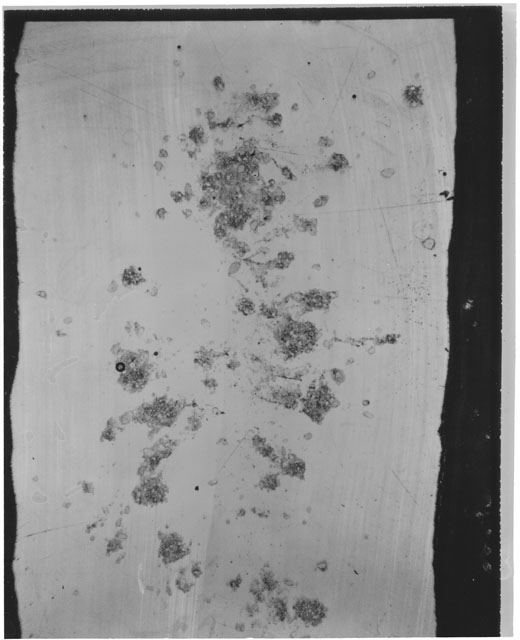 Black and white photograph of Apollo 12 sample 12030,27; Thin Section photograph displaying grain mount.