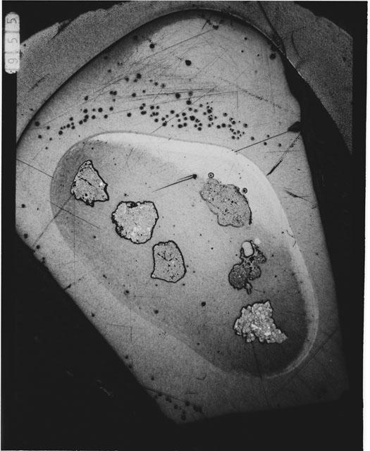 Black and white photograph of Apollo 12 sample 12070,159; Thin Section photograph displaying grain mount.
