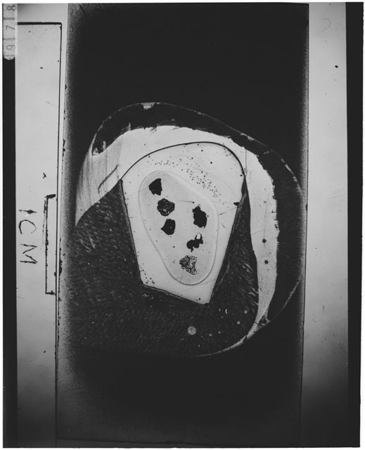 Black and white photograph of Apollo 12 sample 12070,159; Thin Section photograph displaying grain mount.