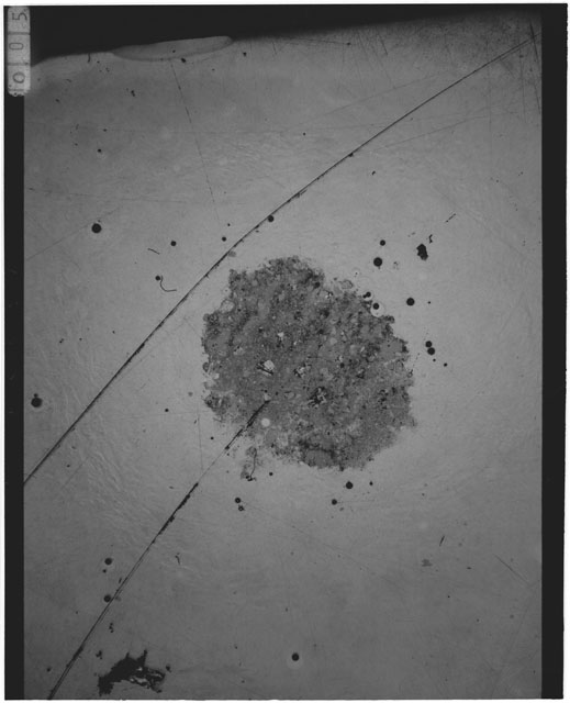 Black and white photograph of Apollo 12 sample 12001,110; Thin Section photograph displaying grain mount.