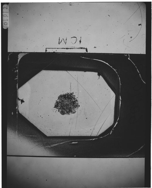 Black and white photograph of Apollo 12 sample 12001,109; Thin Section photograph displaying grain mount.