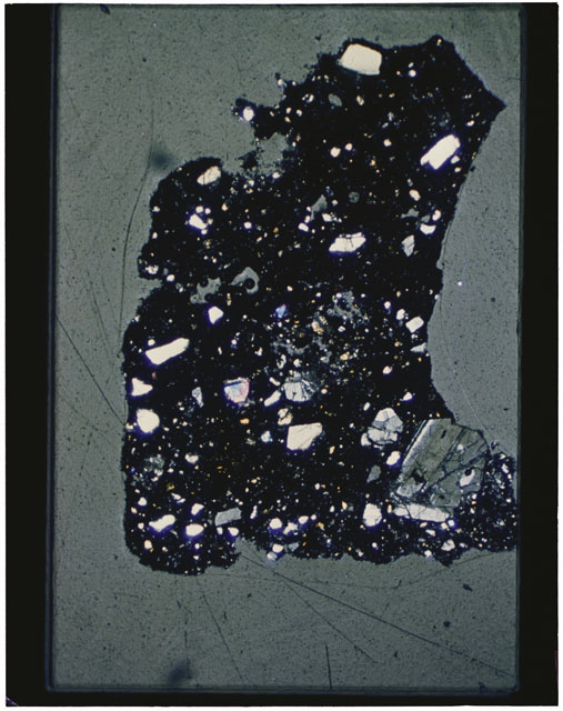 Color photograph of Apollo 12 sample 12001,108; Thin Section photograph displaying grain mount.