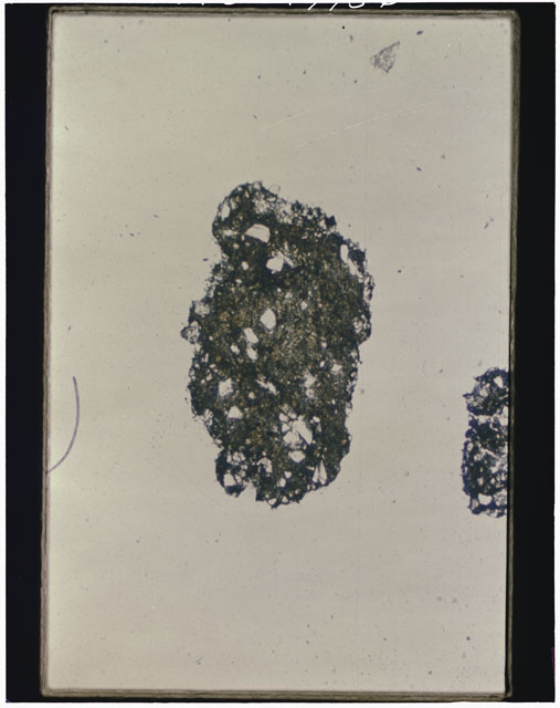 Color photograph of Apollo 12 sample 12001,105; Thin Section photograph displaying grain mount.