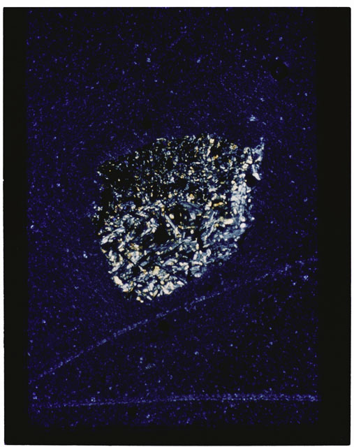 Color photograph of Apollo 11 Sample(s) 10085,73; Thin Section photograph using cross nichols light.
