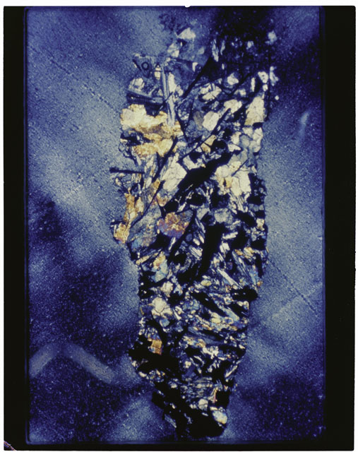 Color photograph of Apollo 11 Sample(s) 10085,66; Thin Section photograph using cross nichols light.