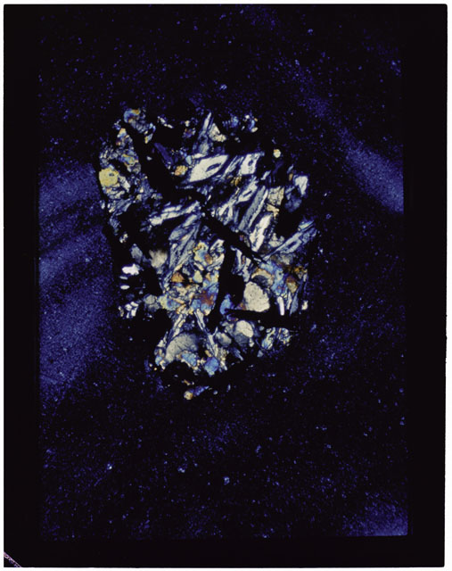 Color photograph of Apollo 11 Sample(s) 10085,64; Thin Section photograph using cross nichols light.