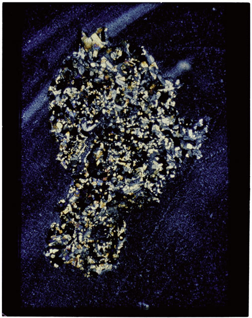Color photograph of Apollo 11 Sample(s) 10085,63; Thin Section photograph using cross nichols light.