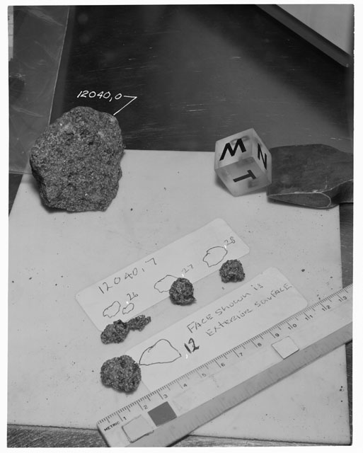 Black and white photograph of Apollo 12 Sample(S) 12040,7,12,26-28; Processing photograph displaying a post chip sample with an orientation of N,W,T.