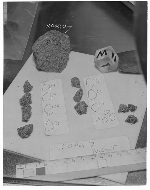 Black and white photograph of Apollo 12 Sample(S) 12040,7,18-25; Processing photograph displaying a post chip sample with an orientation of N,W,T.