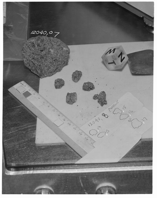 Black and white photograph of Apollo 12 Sample(S) 12040,7,13-17; Processing photograph displaying a post chip sample with an orientation of N,W,T.