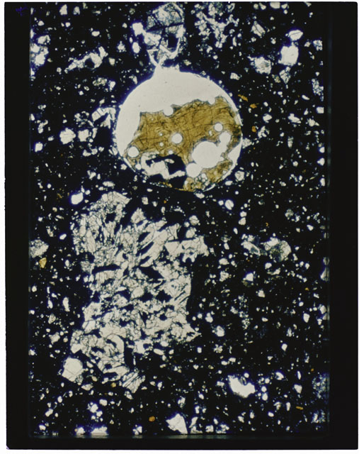 Color photograph of Apollo 11 Sample(s) 10046; Thin Section G photograph using cross nichols light.