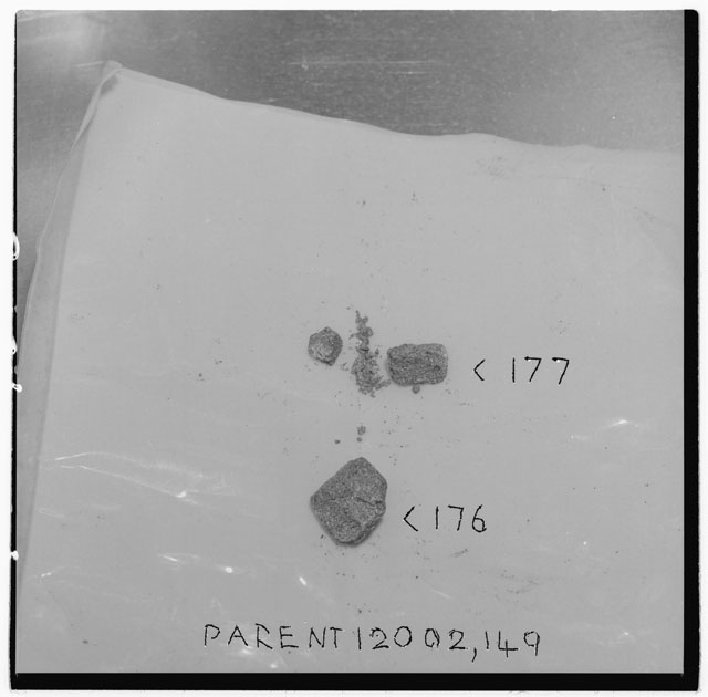 Black and white photograph of Apollo 12 Sample(S) 12002,176,177; Processing photograph displaying chips and fines .
