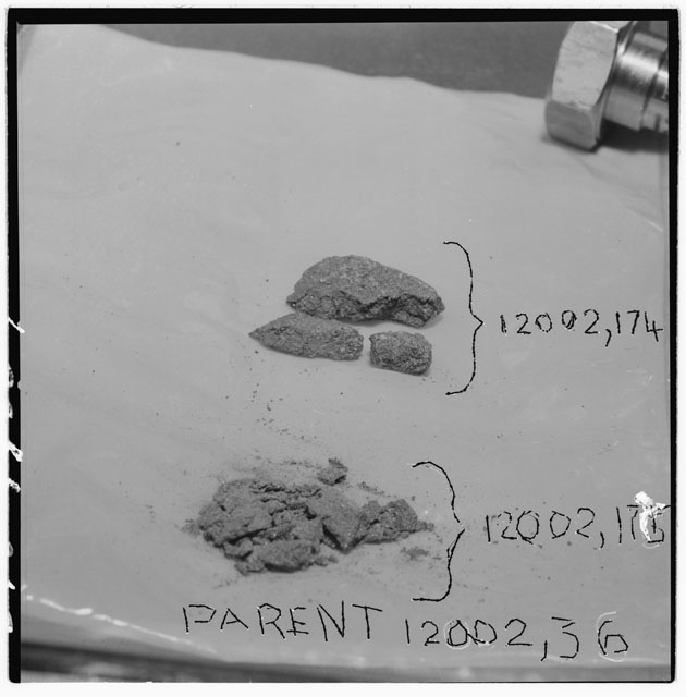 Black and white photograph of Apollo 12 Sample(S) 12002,174,175; Processing photograph displaying chips and fines .