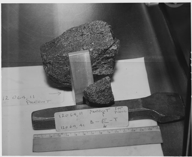 Black and white photograph of Apollo 12 Sample(S) 12064,11,41; Processing photograph displaying a post chip sample with an orientation of E.