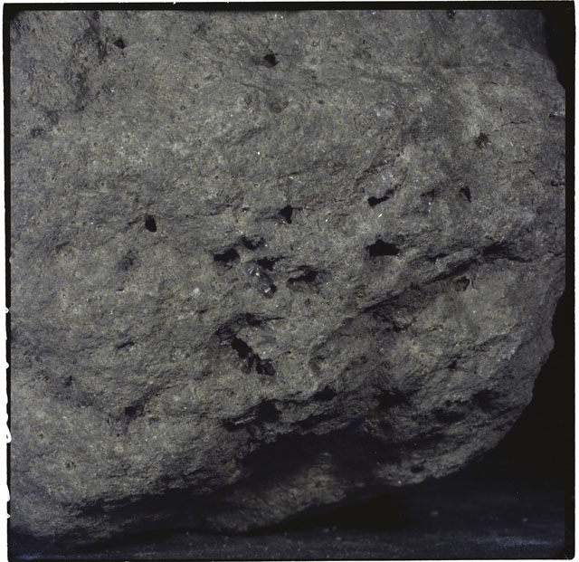 Color photograph of Apollo 12 sample 12052; Processing photograph displaying a close up of the zap pits.