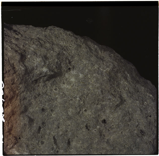 Color photograph of Apollo 12 sample 12052; Processing photograph displaying a close up of the zap pits.
