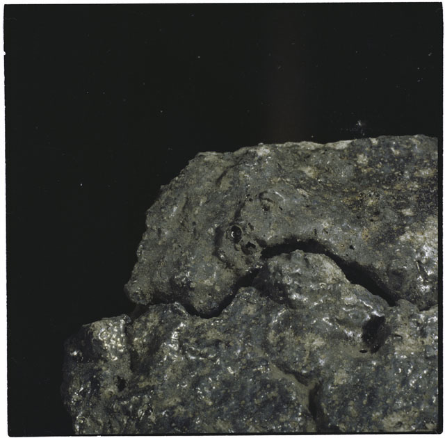 Color photograph of Apollo 12 sample 12054,0; Processing mosaic photograph displaying a close up of the surface.