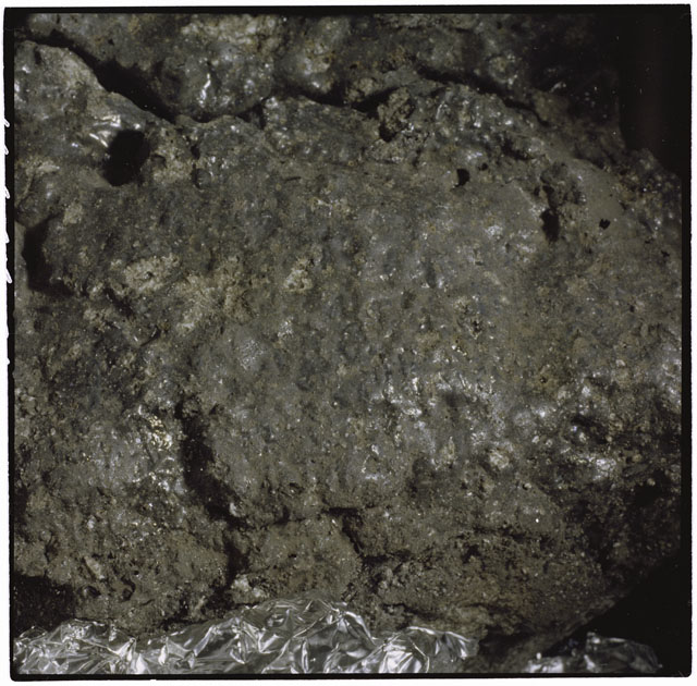 Color photograph of Apollo 12 sample 12054,0; Processing mosaic photograph displaying a close up of the surface.