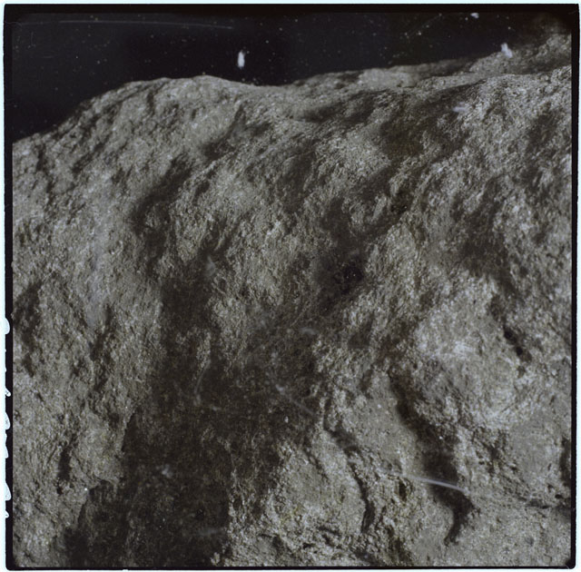 Color photograph of Apollo 12 sample 12063; Processing mosaic photograph displaying a close up of the surface.
