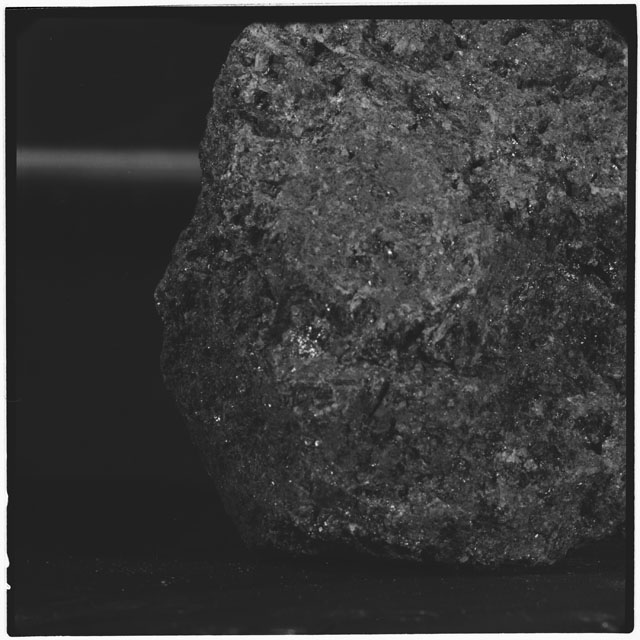 Black and white photograph of Apollo 12 sample 12040; Processing mosaic photograph displaying a close up of the surface.