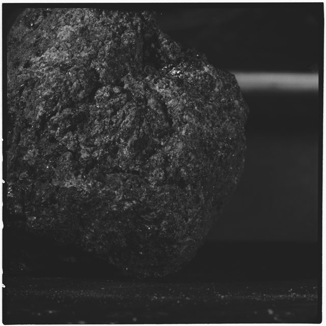 Black and white photograph of Apollo 12 sample 12040; Processing mosaic photograph displaying a close up of the surface.