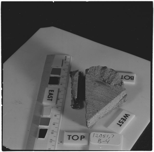 Black and white photograph of Apollo 12 Sample(S) 12051,4,25,26; Processing photograph displaying a post cut sample with an orientation of .