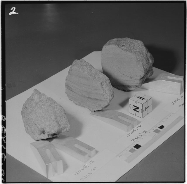 Black and white photograph of Apollo 12 Sample(S) 12065,15-17; Processing photograph displaying a slab reconstruction sample with an orientation of E,N,T.